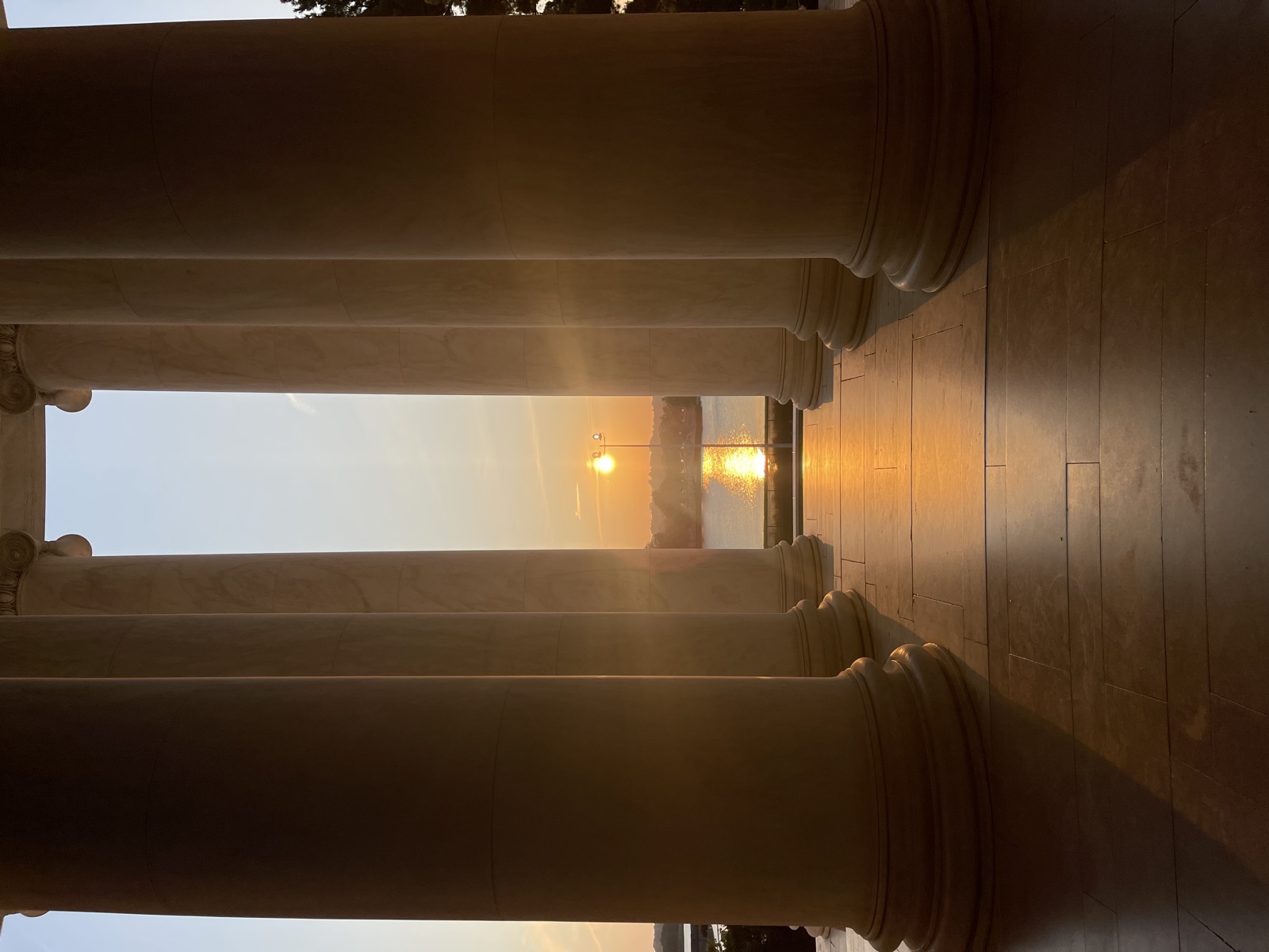 Sunset over the Tidal Basin framed between the Jefferson Memorial’s marble columns